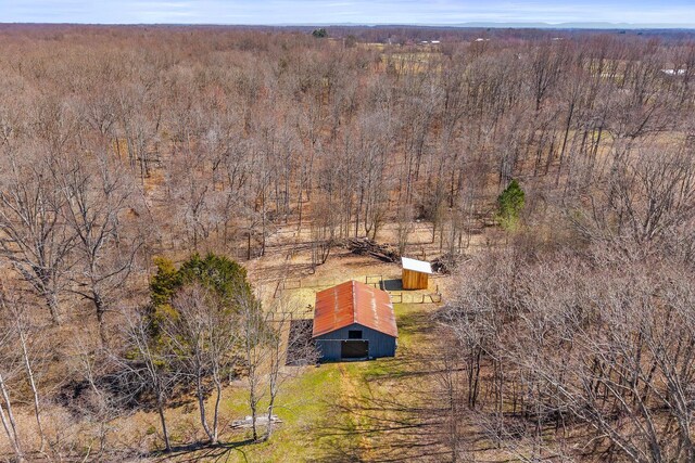 drone / aerial view with a wooded view