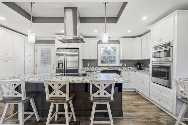 kitchen featuring a center island, island exhaust hood, stainless steel appliances, dark wood-type flooring, and white cabinets