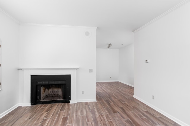 unfurnished living room featuring ornamental molding, wood finish floors, a fireplace, and baseboards