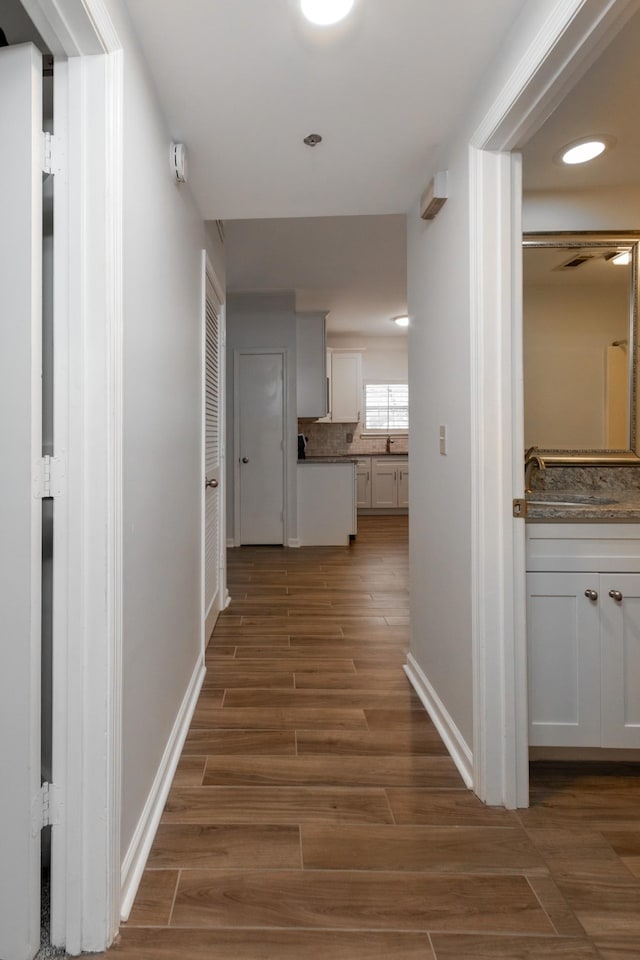 hall with wood tiled floor and baseboards