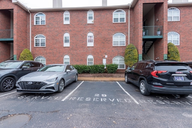 view of building exterior with uncovered parking