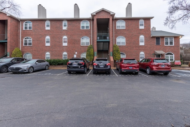 view of building exterior with uncovered parking