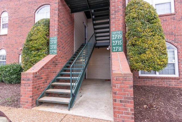 property entrance with brick siding