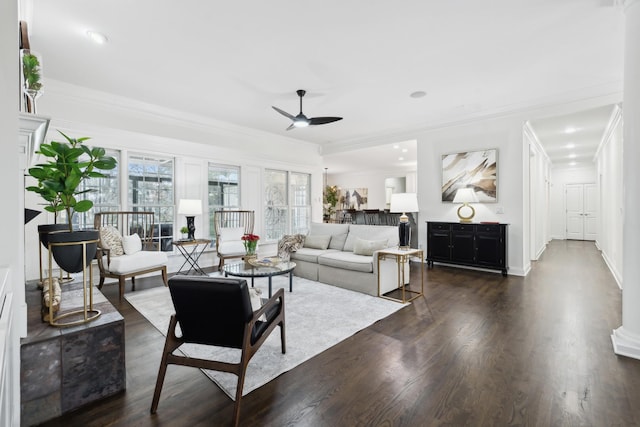 living room featuring baseboards, a ceiling fan, dark wood-style flooring, and crown molding