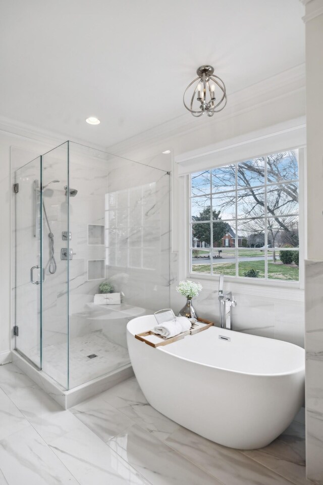 bathroom featuring marble finish floor, recessed lighting, ornamental molding, a shower stall, and a freestanding tub