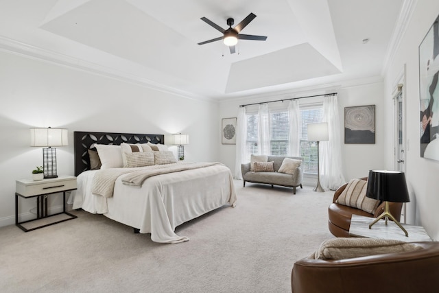 bedroom with baseboards, carpet, a tray ceiling, and crown molding