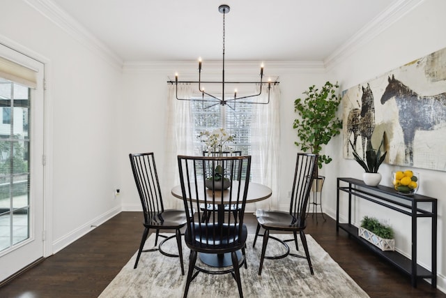 dining space featuring baseboards, crown molding, a chandelier, and wood finished floors