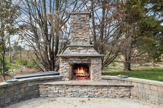 exterior details featuring an outdoor stone fireplace