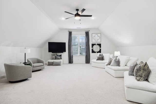 living area with lofted ceiling, ceiling fan, and carpet