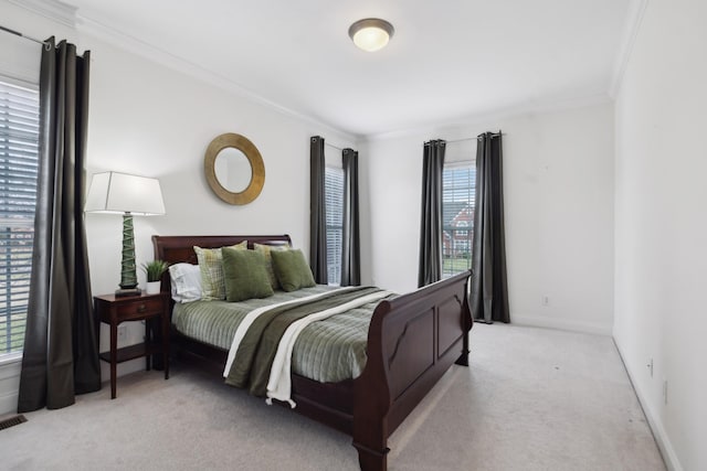 bedroom featuring crown molding, baseboards, visible vents, and light colored carpet