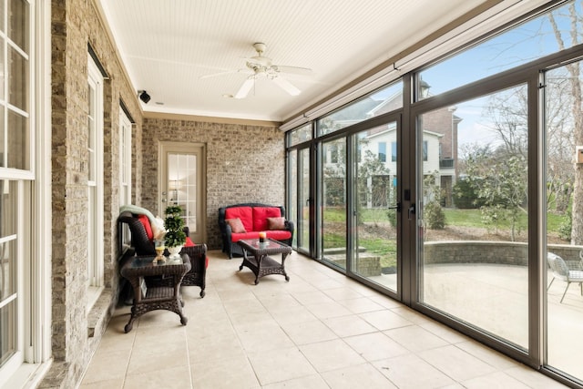 sunroom / solarium featuring a ceiling fan