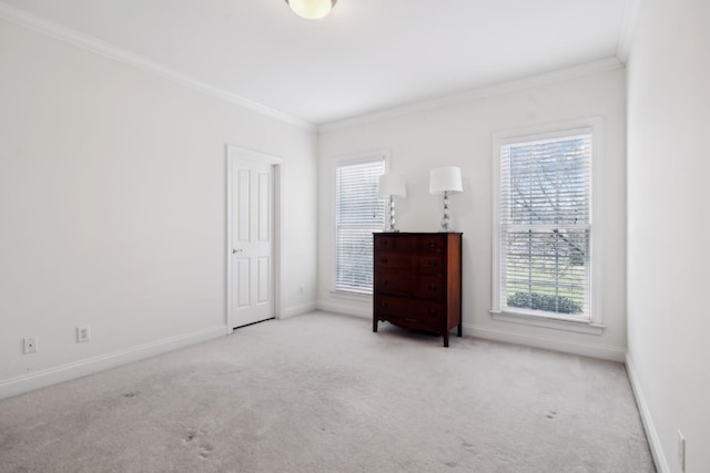 unfurnished bedroom featuring ornamental molding, carpet flooring, and baseboards