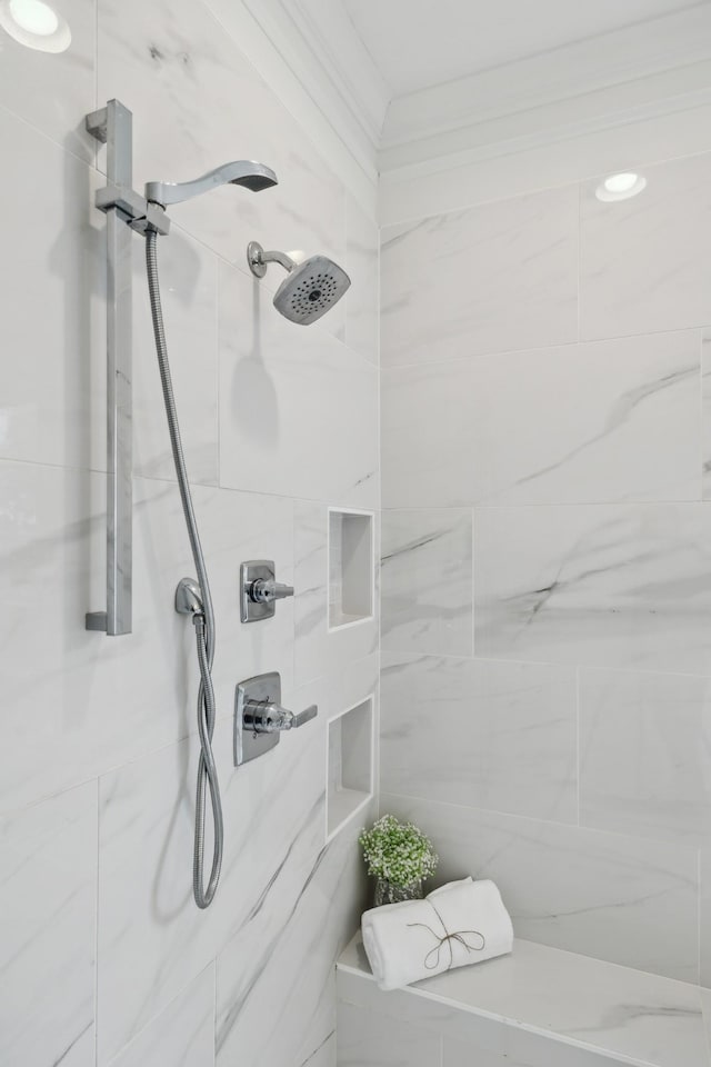 full bathroom with a tile shower and crown molding