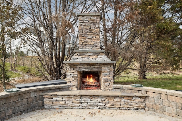 details with an outdoor stone fireplace