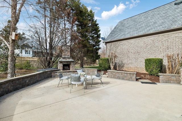 view of patio / terrace featuring an outdoor stone fireplace