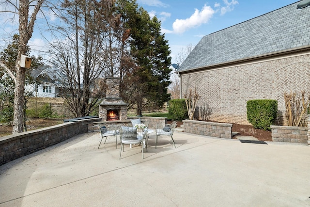 view of patio with an outdoor stone fireplace