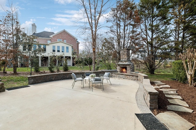 view of patio featuring an outdoor stone fireplace