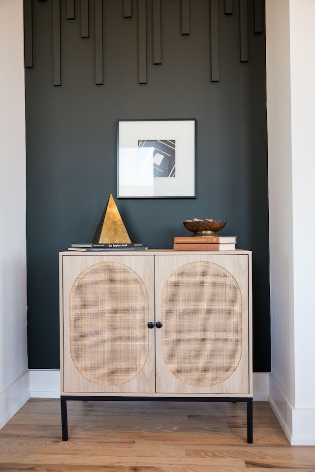 interior details with baseboards and wood finished floors