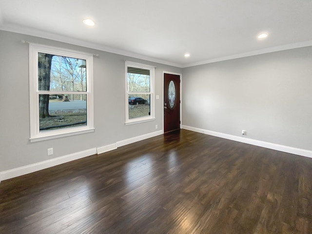 entrance foyer with crown molding, baseboards, and dark wood-style flooring