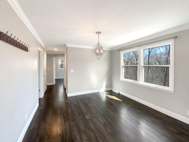 unfurnished dining area featuring ornamental molding, dark wood finished floors, baseboards, and an inviting chandelier