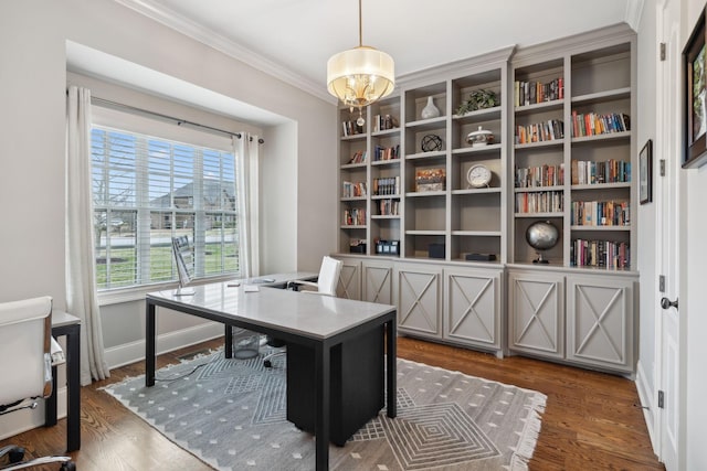 office space with ornamental molding, a notable chandelier, baseboards, and wood finished floors