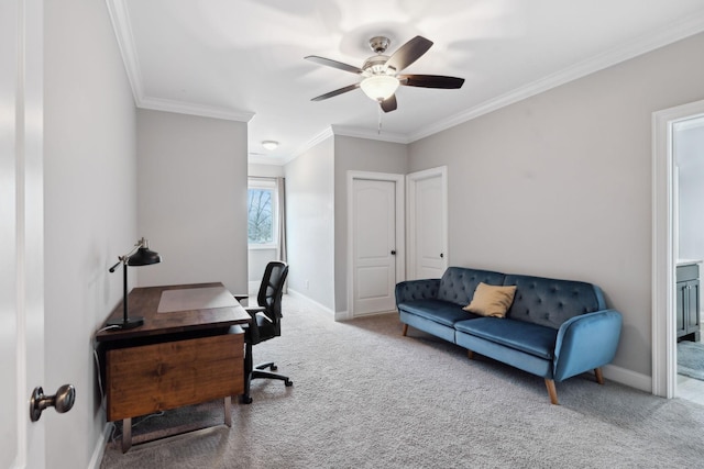 carpeted home office with a ceiling fan, baseboards, and crown molding