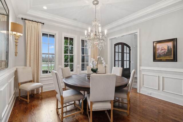 dining room with ornamental molding, a decorative wall, dark wood-style flooring, and french doors