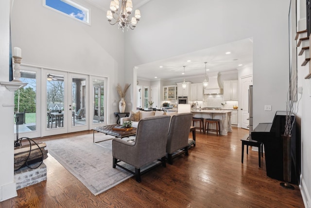 living area featuring dark wood-style floors, french doors, a notable chandelier, crown molding, and recessed lighting