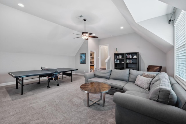 living area with carpet floors, baseboards, visible vents, and vaulted ceiling