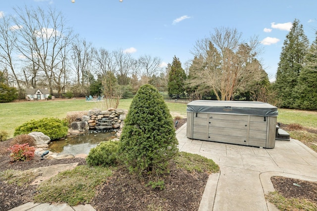 view of yard with a patio area, fence, and a hot tub