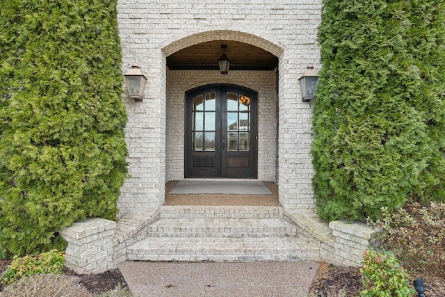 property entrance with french doors and brick siding