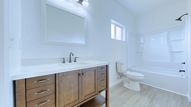 full bath with baseboards, shower / washtub combination, toilet, wood finished floors, and vanity