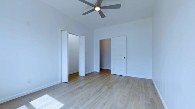 unfurnished bedroom featuring ceiling fan, baseboards, and wood finished floors