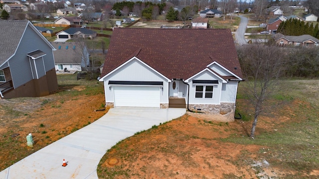 view of front of property with an attached garage, a shingled roof, concrete driveway, crawl space, and a residential view