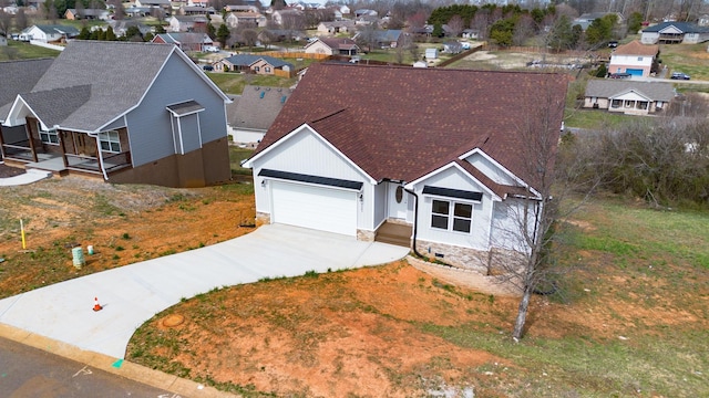 view of front of home featuring roof with shingles, an attached garage, concrete driveway, crawl space, and a residential view