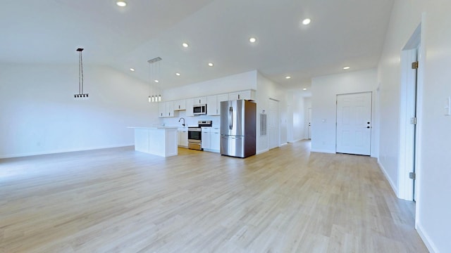 unfurnished living room with recessed lighting, baseboards, vaulted ceiling, and light wood finished floors