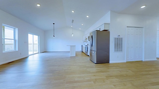 kitchen with visible vents, freestanding refrigerator, light wood-style floors, white cabinetry, and open floor plan