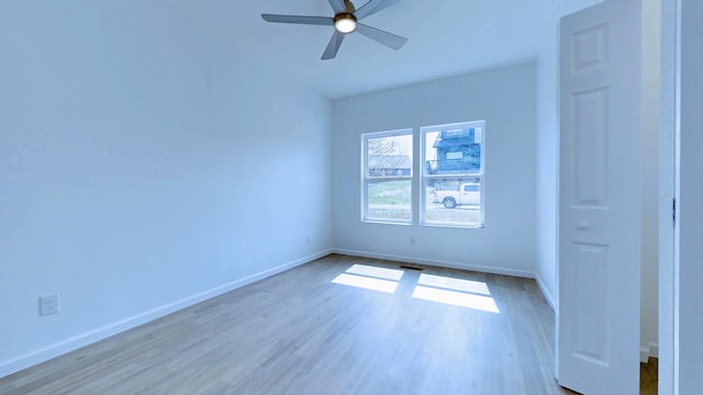 unfurnished bedroom with a ceiling fan, visible vents, wood finished floors, and baseboards