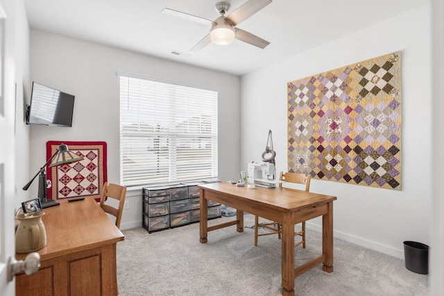 office featuring ceiling fan, baseboards, visible vents, and light colored carpet