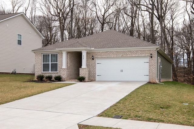 view of front of house with driveway, brick siding, an attached garage, and a front yard