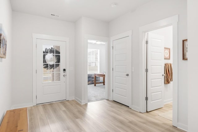 entryway featuring light wood-type flooring, visible vents, and baseboards