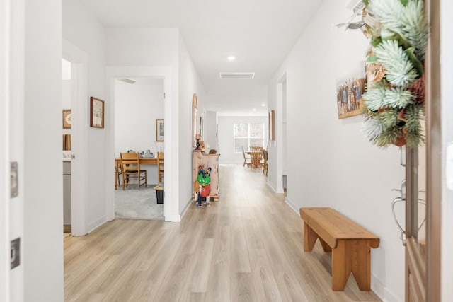 corridor featuring recessed lighting, baseboards, visible vents, and light wood finished floors