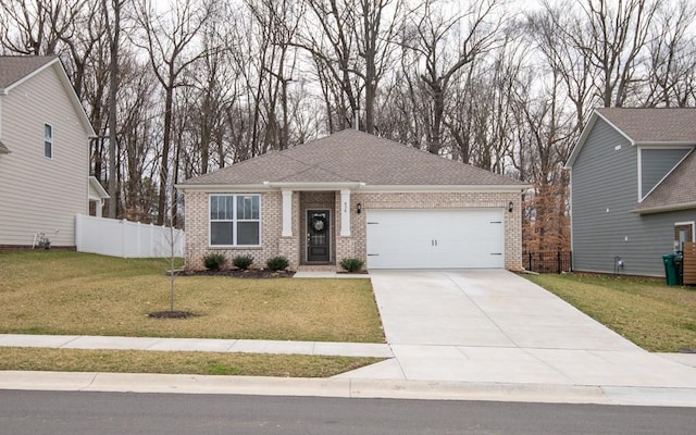 view of front of house with a garage, brick siding, a front lawn, and fence