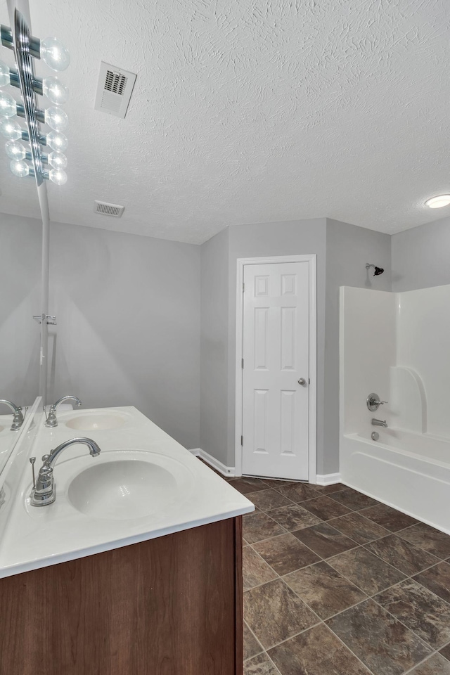 full bath with bathtub / shower combination, visible vents, and a sink