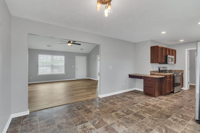 kitchen with stainless steel appliances, a textured ceiling, baseboards, and a ceiling fan