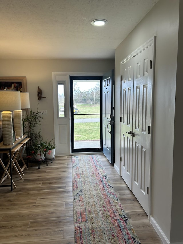 entrance foyer with light wood-type flooring and baseboards