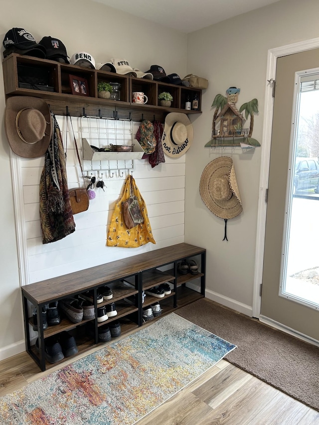 mudroom with wood finished floors and baseboards