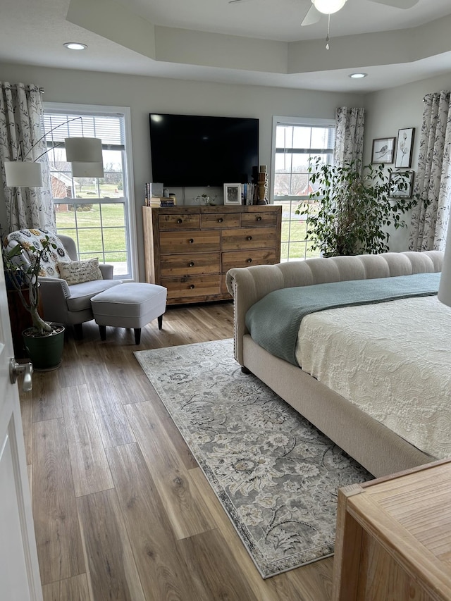 bedroom with recessed lighting and wood finished floors