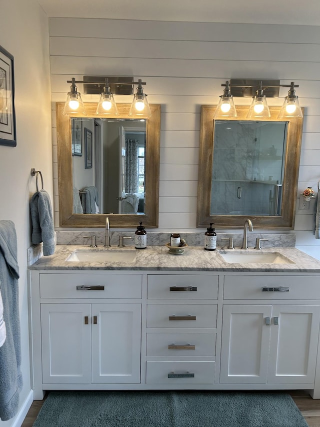 full bathroom featuring double vanity and a sink