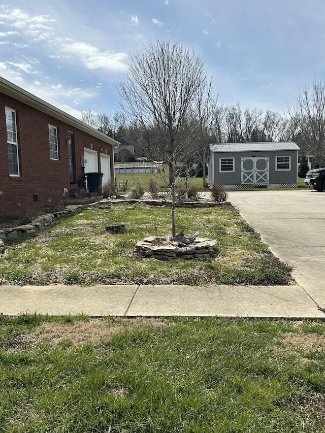 view of yard with a garage and an outbuilding